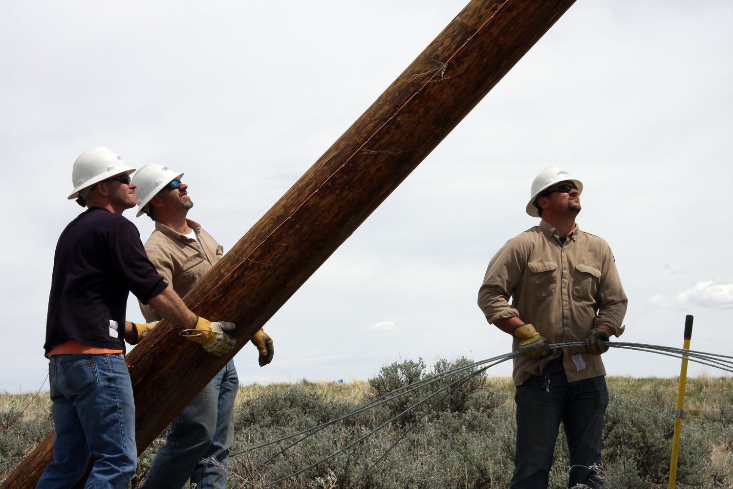 Linemen Carrying Pole